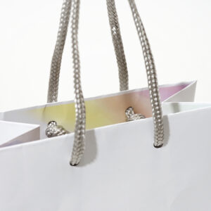 シンプルなホワイトに、口折り部分のレインボーカラーが華やかなアクセントとなるオリジナル紙袋