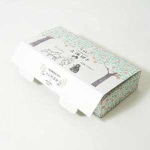 桃太郎のイラストの可愛らしい世界観をフルカラー印刷で表現した、岡山の老舗和菓子店が手がける箱型のオリジナルパッケージ