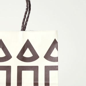 紙紐ハンドルを採用した、菓子メーカーのロゴが印象的でエコなオリジナル紙袋