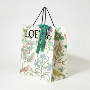 ロゴに浮き出し加工を施し、ワックスコードハンドルを使用した高級ファッションブランドのホリデーシーズン限定オリジナル紙袋