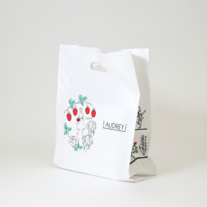 人気スイーツブランドのブランドのシンボルである、赤いワンピースの女の子が描かれたオリジナルポリ袋