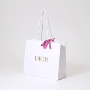 有名コスメブランドの純白ボディに映える、高級感のある箔押しロゴとピンクリボンが可愛いオリジナル紙袋