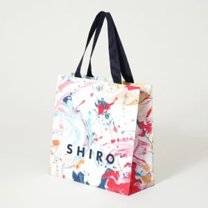 新星アーティストによる大胆なインクアートをフルカラー印刷で再現した、コスメブランドのオリジナル紙袋