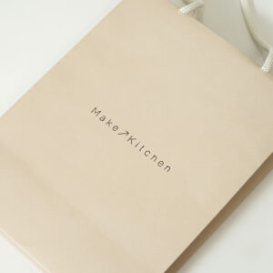 淡いカラーリングが全面に印刷された、ナチュラル・オーガニックコスメショップのオリジナル紙袋