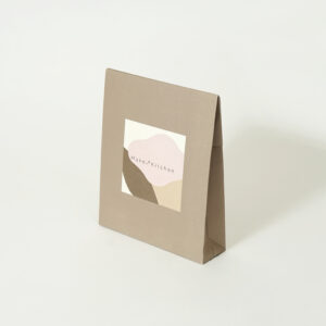 淡いカラーリングが全面に印刷された、ナチュラル・オーガニックコスメショップのプレゼントバッグ