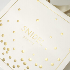 マットPP加工を施したボディに箔押し加工でドット模様とロゴを印字した、コスメブランドの高級感あふれるオリジナル紙袋