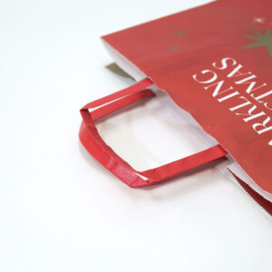 ゴールドのクリスマスツリーと星がデザインされた、クラフト紙に全面フルカラー印刷された、フラワーショップのホリデー限定オリジナル紙袋